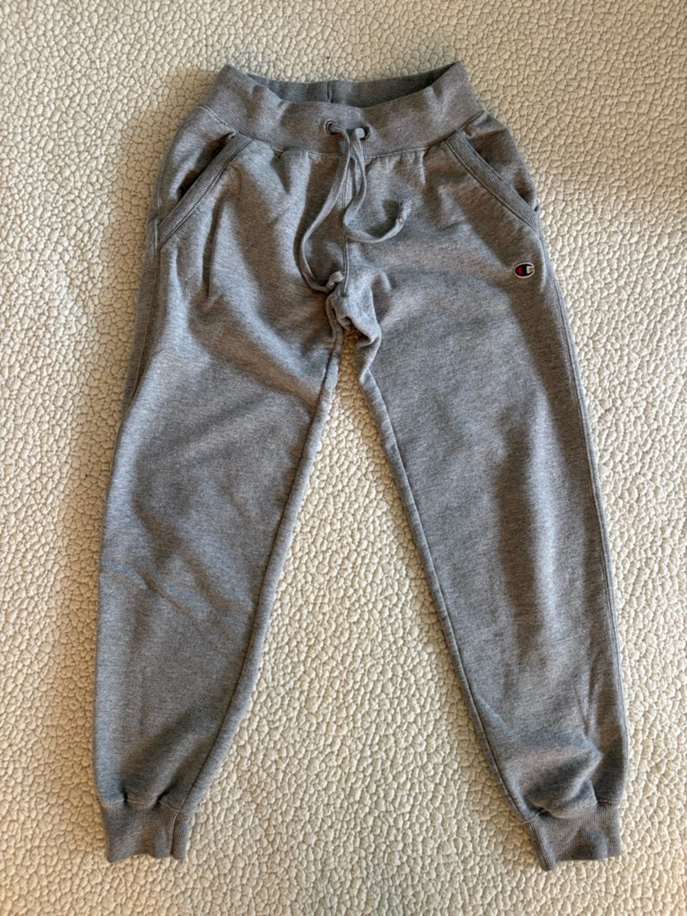 Champion grey jogger sweatpants with classic logo detail.